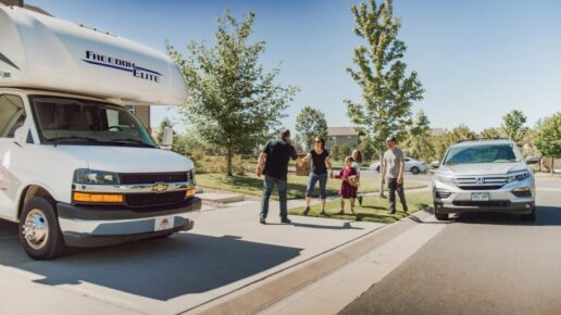 A picture of consumers getting keys to an RV rental at their home.