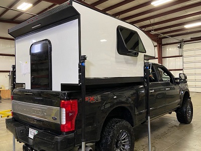 A picture of a 2023 Soaring Eagle truck camper situated in a truck bed