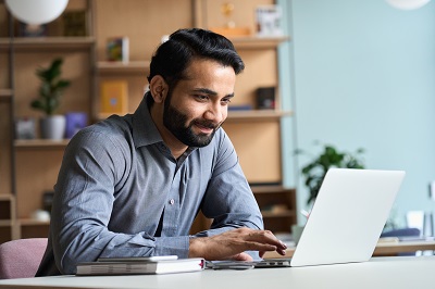 A picture of a man at a laptop computer