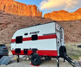 A picture of a Sunset Park RV towable with a mountain back drop.