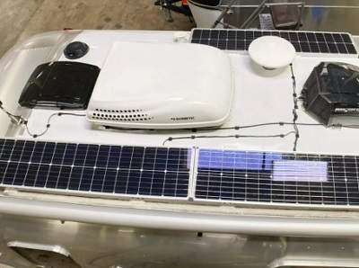 A picture of an Airstream travel trailer with solar panels added to its roof as a power upgrade from Ultimate Airstream