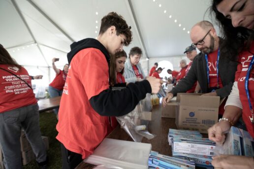 A picture of volunteers assembling packages at the seRV With Purpose event at the Jayco Jubilee in Tampa, Florida, Jan. 17.
