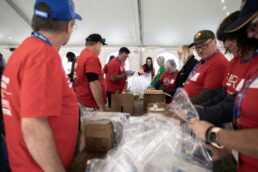 A picture of volunteers assembling packages at the seRV With Purpose event at the Jayco Jubilee in Tampa, Florida, Jan. 17.
