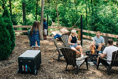 A picture of a GE Appliances 2023 Cooler and a family camping