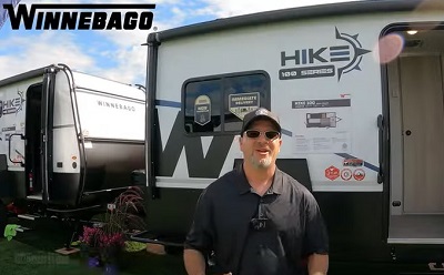 A screenshot of a tour of a Winebago Hike 100 travel trailer at Hershey America's Largest RV Show