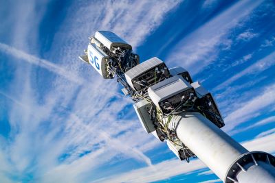 A picture of a 5G cell tower against the blue sky