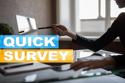 A picture of a quick survey graphic overlay in front of a photo of a woman pinting to an online computer