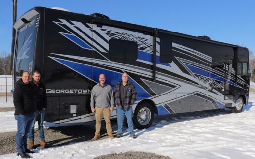 A picture of Firefly Integrations Team standing outside a Georgetown Type A motorcoach