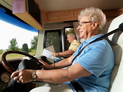 A picture of an older couple driving a motorized RV