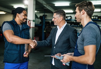 A picture of men having a discussion in a parts and service area