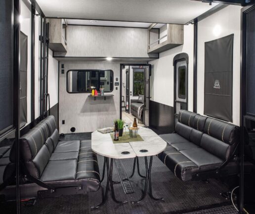A picture of the interior dining room of the 2023 KZ RV Robby Gordon Spee _UTV Venom V series 3916RG