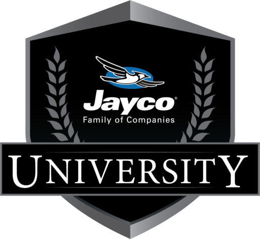 A picture of the Jayco University logo, a black and white coat of arms with a blue Jayco bird in the center