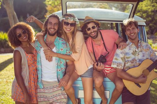 A picture of a bunch of young adults at a music festival in the back of a Type B RV