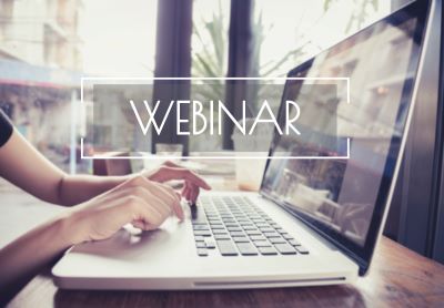 A picture of a pair of female hands typing on a laptop with an text overlay saying, "Webinar"