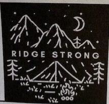 A picture of "Ridge Strong" a graphic showing mountains and camping in honor of infant Ridge Carlton who is in the hospital