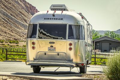 A picture of an Airstream trailer from the rear in Grand Junction with vinyards and a mesa in the background