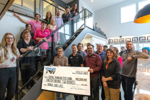A picture of Voyager RV employees presenting a check to the CO Food Bank