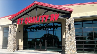 A picture of an ET Quality RV location with red lettering on a tan building