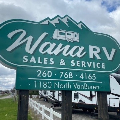 A green sign with white letters outside the Wana RV Sales & Service center/dealership in Shipshewana, Indiana.
