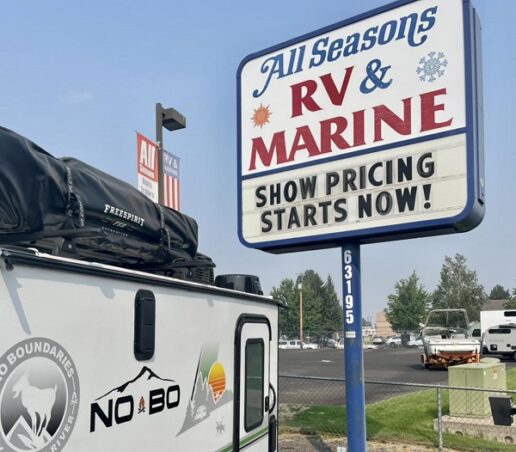 A picture of a Forest River NoBo travel trailer next to the All Seasons RV & Marine sign, before the company was sold to Camping World
