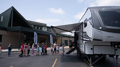 A picture of girls and boys standing in line to tour a Jayco RV at the RV Day in 2023 Midlebury Indiana