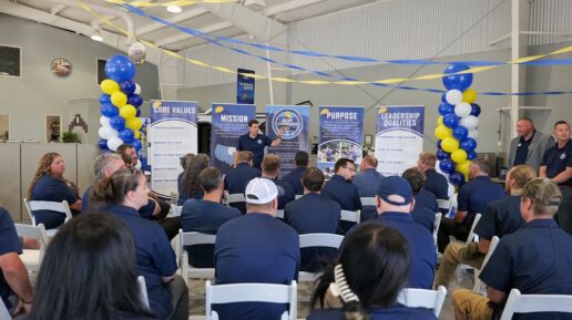 A picture of Blue Compass RV President and CEO Jon Ferrando addressing store employees during the brand rollout of Pacific Northwest dealership stores.