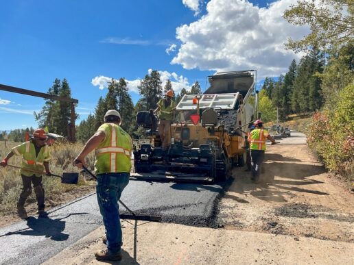 A picture of construction workers doing ground repairs at a national park.