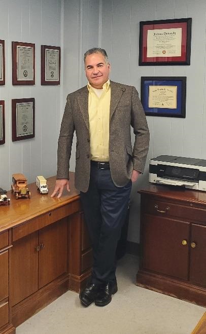 A picture of John Stuart, the president of Reyco Granning, standing in his office. Stuart plans to retire in August 2023.