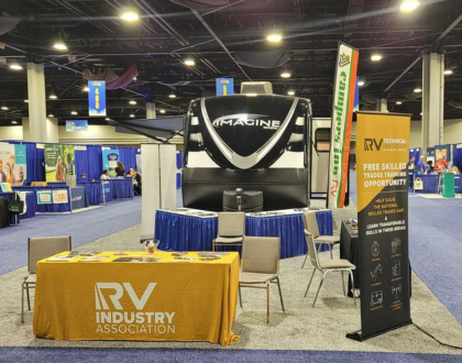 A picture of the RVTI booth at an Atlanta educators conference featuring a Grand Design Imagine RV.