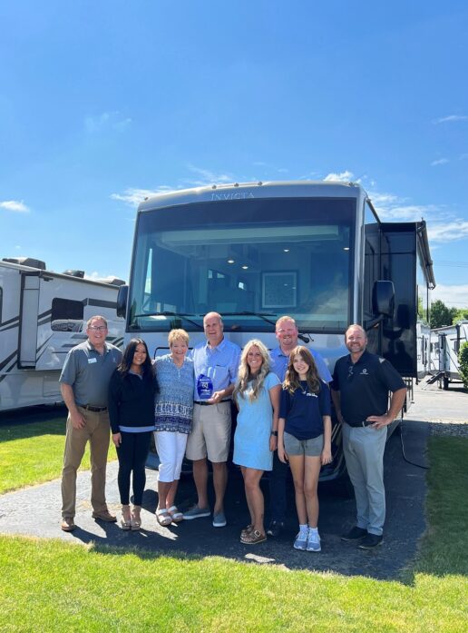 A picture of the Veurink's RV Center team in front of a Holiday Rambler motorhome.
