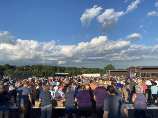 A picture of attendees streaming past the entrance at the start of the 2022 Winnebago Grand National Rally. The event has been renamed Camp Winnebago in 2023.