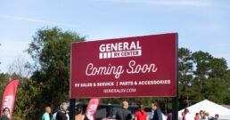 A picture of a sign at the groundbreaking of a new General RV dealership store in Salisbury, North Carolina saying "Coming Soon."