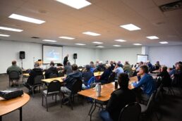 A picture of Heartland RVers sitting through an educational session at the Elkhart County Fairgrounds for the 2023 Heartland RV Owners Rally.