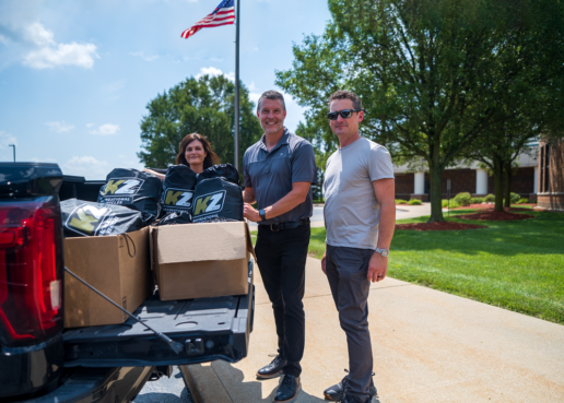 A picture of (L to R) KZ RV VP of Sales and Marketing Marlene Snyder, KZ RV President Ryan Juday and KZ RV VP of Service Operations Sean Andrews unloading supplies for an elementary school donation.