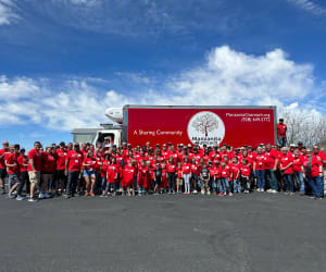 A picture of Lippert volunteers gathered in front of a truck during a charity event.