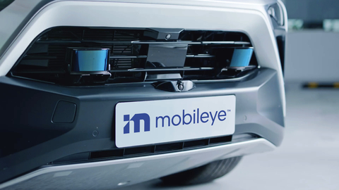 A picture of the Mobileye logo on the bumper of a vehicle.