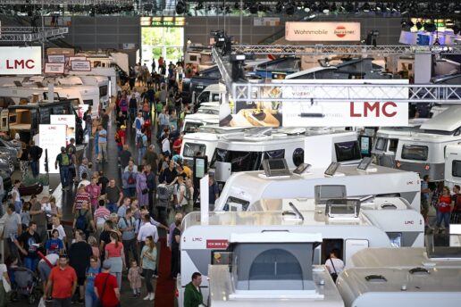 A picture of the Caravan Salon 2023 crowd walking through the exhibit floor and past RVs on display.