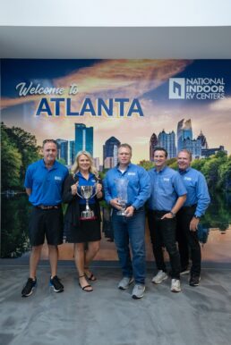 A picture of the National Indoor RV Centers team in Georgia accepting its Entegra Coach top dealer awards.