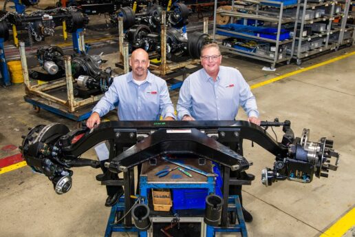 A picture of Freightliner Custom Chassis Corp.'s Jeremy Buckmeier and Bryan Henke standing with the supplier's new V-Series VFS front suspension.