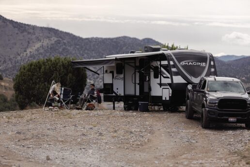 A picture of the 2024 Grand Design Imagine outside in a Utah camping space.