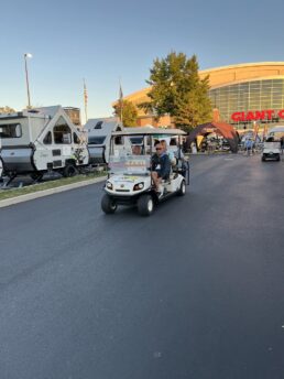 A picture of consumers on a golf cart preparing to enter America's Largest RV Show in Hershey, Pennsylvania, on its final day.