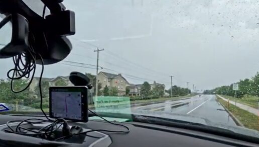 A screenshot of a camera looking out a car's front windshield covered in rain as the Our Road Less Traveled couple wraps up their experience at the 2023 America's Largest RV Show in Hershey, Pennsylvania.