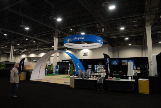 A picture of a booth at the 2023 Jayco Dealer Homecoming displaying numerous marketing tools for dealers.