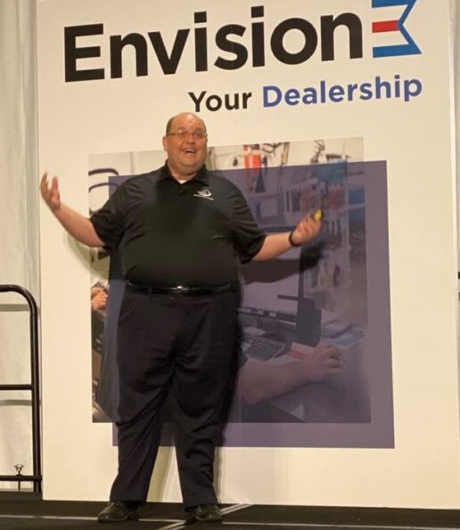 A picture of Dealership Toolkit CEO Rich DeLancey giving a presentation at a national marine show in 2019.