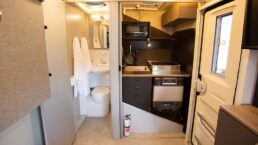 A picture of the SylvanSport Vast's interior with the kitchen inside, occupying the shower stall, and the toilet/sink to the left of the kitchen.