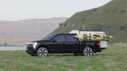 A picture of Camp365's T Model truck camper, folded for transit, in the bed of a Ford pickup.