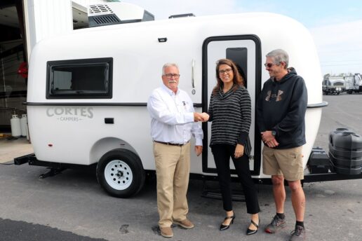 A picture of Scott Geesey, general manager, Liberty RV of Gettysburg, presents a 2024 Cortes 16 RV to Hershey America’s Largest RV Show giveaway winner Jennifer Schiavone-Blake and her husband John Blake. The giveaway was sponsored by Cortes Campers and Liberty RV of Gettysburg.