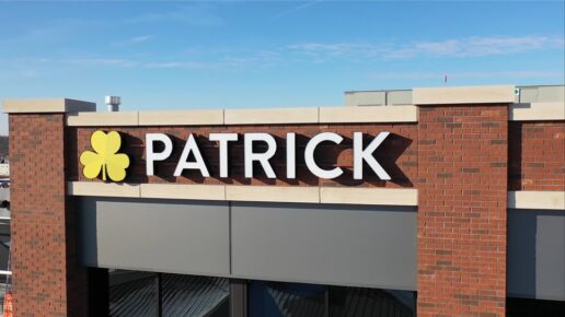 A picture of the Patrick Industries logo atop a brick building.