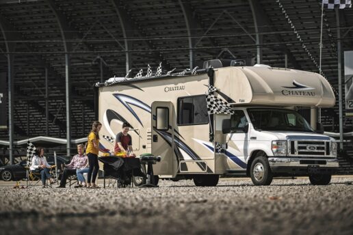 A picture of a family tailgating with its Type C Chateau motorhome at a stadium.