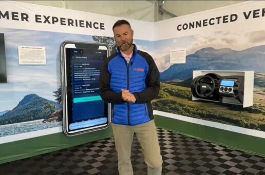 A picture of Go RVing's Mike Caudill in front of a technology display at Thor Industries' Open House display.